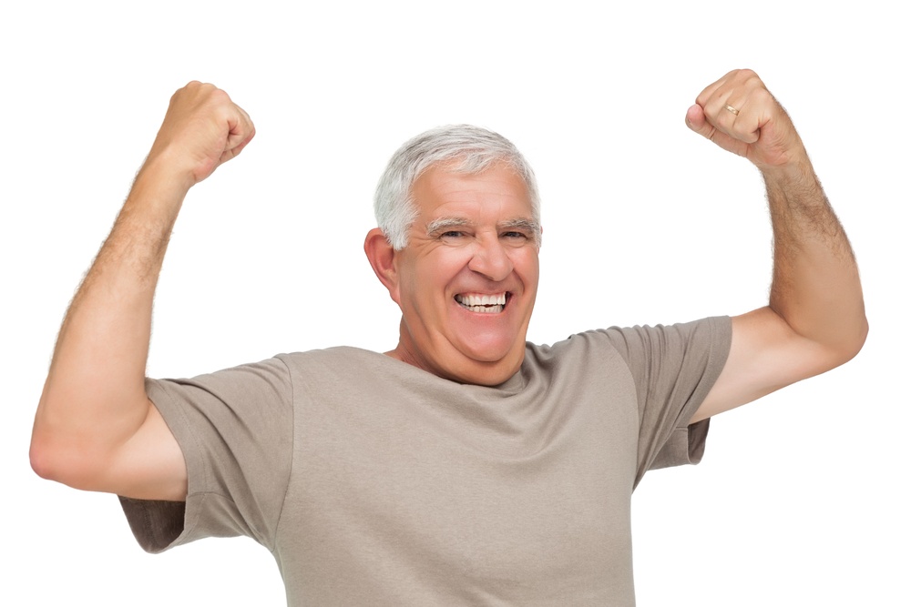 Portrait of a cheerful senior man with clenched fists over white background